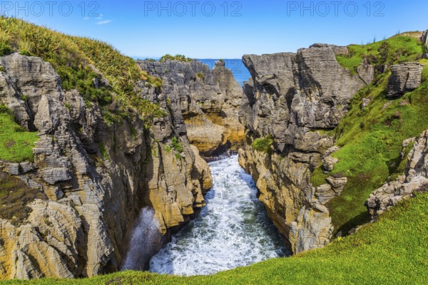 Picturesque coast of the South Island of New Zealand. Pancake rocks form narrow bays and fjords. The concept of photo and ecological tourism
