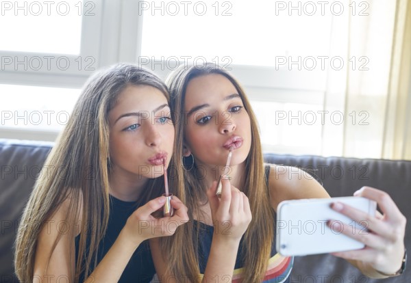 Teenager girls best friends makeup selfie camera in smartphone make-up