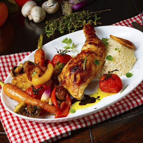 Rustic fried chicken legs with assorted vegetables and rice