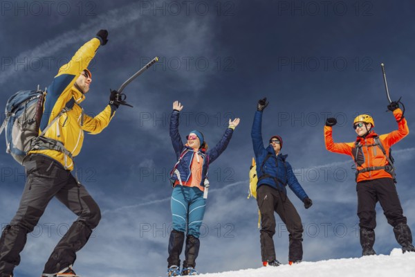 Mountaineer backcountry ski touring in the mountains. Ski touring in high alpine landscape with snowy trees. Adventure winter extreme sport.
