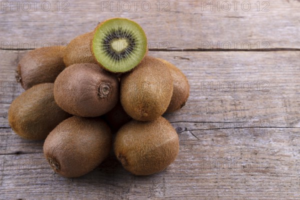 Pile of fresh kiwi on an old wooden board
