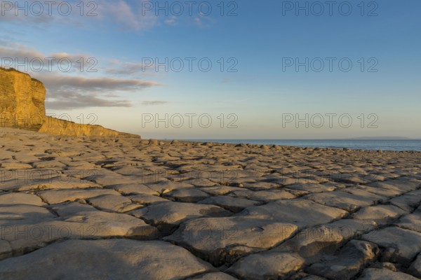 The stones and cliffs of Llantwit Major Beach in the evening sun, South Glamorgan, Wales, UK