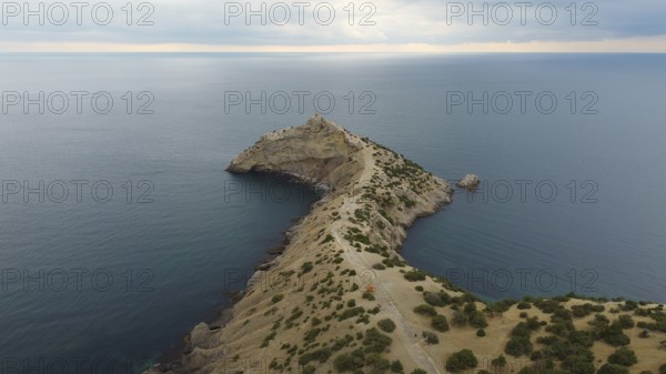 Autumn morning and a mountain landscape by the sea, a promontory protruding into the water