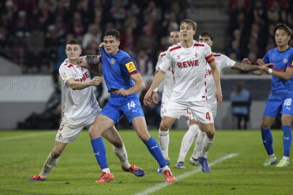 Eric Martel (1.FC Köln, Midfield, #6), Max Geschwill (Defence, Holstein Kiel, #14), DFB Pokal: 1.FC Köln, Holstein Kiel on 29/10/2024 at the RheinEnergieStadion in Cologne Germany . (DFL/DFB REGULATES PROHIBIT ANY USE OF PHOTOGRAPHS AS IMAGE SEQUENCES AND/OR QUASI-VIDEO), RheinEnergieStadion, Cologne, North Rhine-Westphalia, Germany, Europe