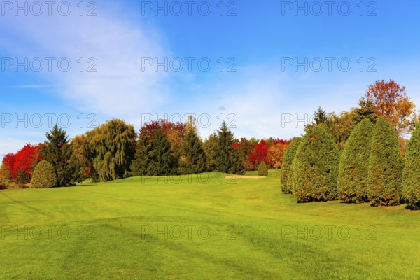 Canada, province of Quebec. The road from Montreal to Bromont. Green lawns, trees with green, yellow, orange and red foliage.The magic of multicolored autumn, North America