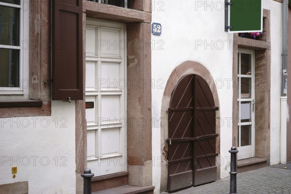 Heavy wooden doors and gates of a shop and residential building in the old town centre