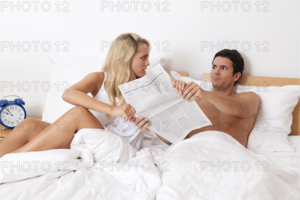 A young couple in bed having problems and crisis. Divorce and separation, A young couple in bed having problems and crisis. Divorce and separation. Austria