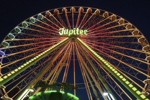 Ferris wheel illuminated at night, perspective, bright lights, many colours, funfair in Bad Arolsen, 9 August 2015, Germany, Europe
