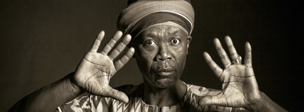 African man in traditional clothes toothy smile, on grey background