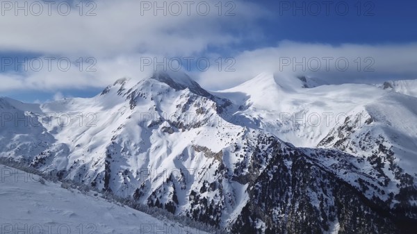Beautiful Pirin mountains peaks covered with snow. Winter view at Bansko ski resort in Bulgaria