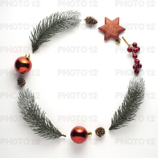Creative concept still life holiday Christmas photo of fir branches and berries in the shape of wreath on white background