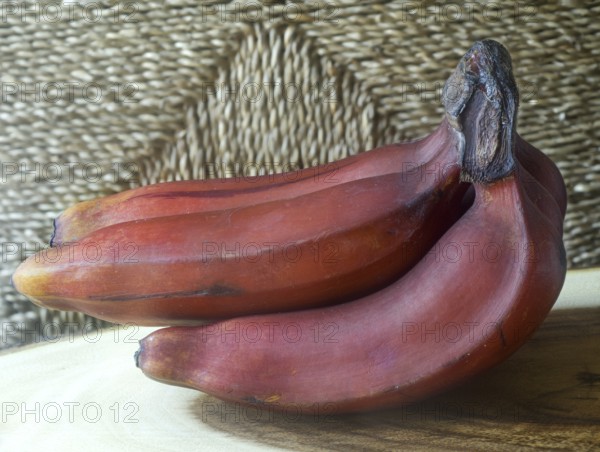 Red bananas on teak wood