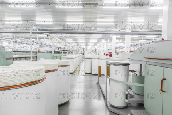 Machinery and equipment in the workshop for the production of thread, overview. interior of industrial textile factory