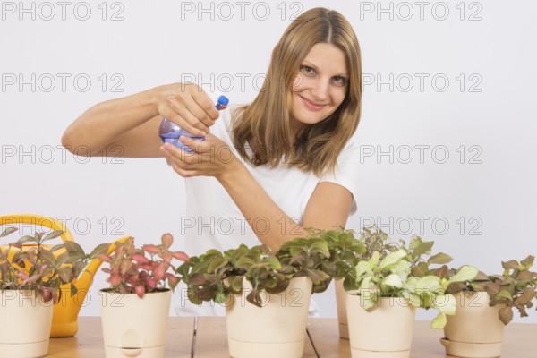 Young girl Europeans care and watering potted plants Fitton
