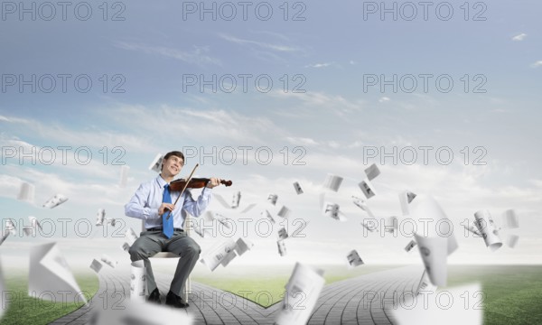 Young businessman is engaged in music, concept of creative chaos in business