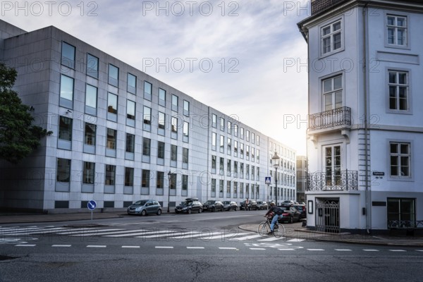 Copenhagen, Denmark, August 10, 2016. Man biking in the street of Copenhagen at sunset with sunlight on background, Europe