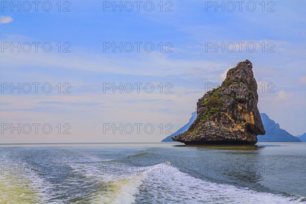 Fantastic beauty island-rock in the southern seas. The photo was taken from a fast sailing boat