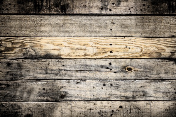 Horizontal wooden planks forming a textured background, weathered and showing knots and grain.Belarus