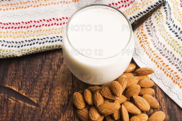 Almond milk with almond on a wooden table