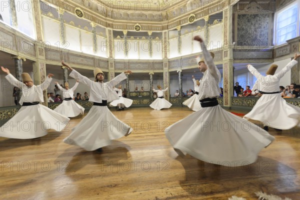 Dancing dervishes, Dervish dance Sema, Mevlevihanesi Müzesi at Istiklal Caddesi, Istanbul, European part, Turkey, Asia, A group of dervishes dances synchronously in white robes on a wooden floor surrounded by spectators, Istanbul province, Traditional dervish dance in impressive movement and stylish surroundings, Istanbul Modern, Asia