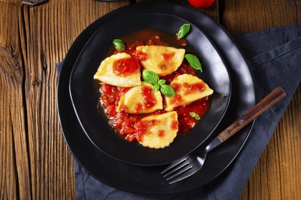 Ravioli alla genovese with basil and tomato sauce
