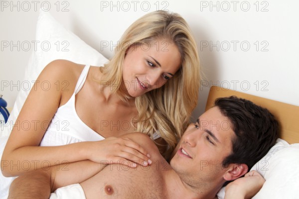 Couple has fun in bed. Laughter, joy and eroticism in the bedroom, Couple has fun in bed. Laughter, joy and eroticism in the bedroom Austria