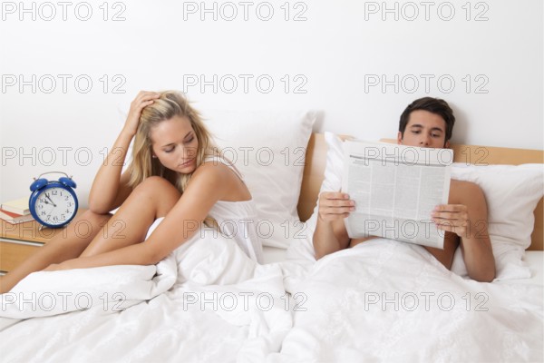 A young couple in bed having problems and crisis. Divorce and separation, A young couple in bed having problems and crisis. Divorce and separation. Austria