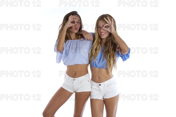 Teen best friends girls happy together looking through finger goggles