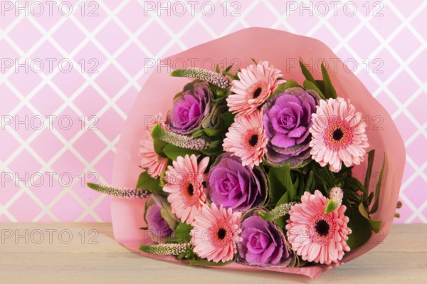 Colorful wrapped pink and purple bouquet in interior