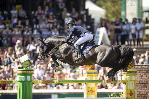 Denis Lynch of Ireland and riding Vistogrand compete in the first round of the 1.60m CPKC International during the Spruce Meadows Masters, presented by Rolex, in Calgary, Alberta, Canada, North America