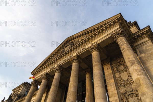 Berlin, Germany, July 28, 2019: Close-up low angle view of famous Reichstag building, seat of the German Parliament, Deutscher Bundestag, at sunset, Europe