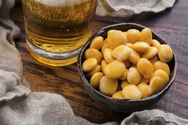 Tasty lupins and glass of beer. Beverage, legume