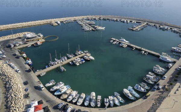 Drone aerial scenery of a fishing port. Fishing boats and yachts moored in the harbour. Zygi marina Cyprus