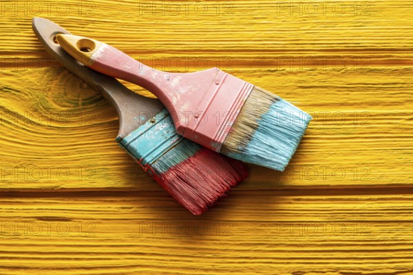 Coral color and yellow vivid grunge brushes on aged painted wood