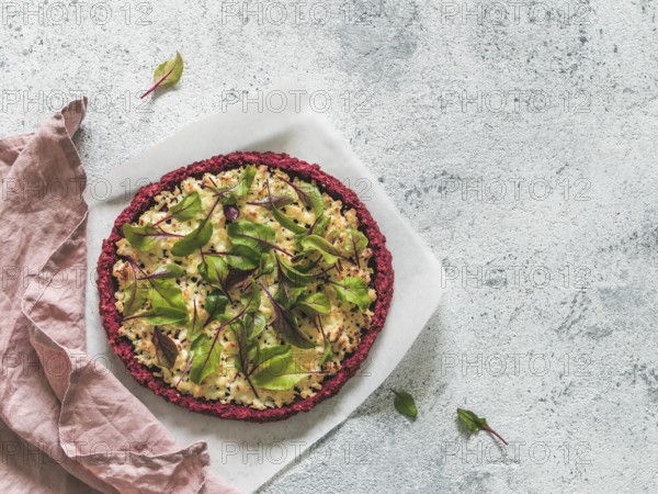 Beetroot pizza crust with fresh swiss chard or mangold beetroot leaves.Ideas and recipes for healthy vegan snack.Egg-free pizza crust with chia seed and wholegrain brown rice flour.Copy space.Top view