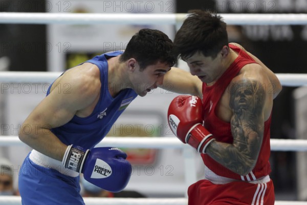Sofia, Bulgaria - 26 February, 2021: Kots Maxim (red) of Ukraine and Dilshodbek Ruzmetov of Uzbekistan fight in their semifinal round of Light Heavy (81kg)category of the 72-nd International Boxing Tournament Strandja 2021, Sofia, Bulgaria, Europe