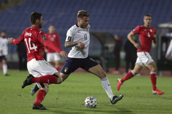 Sofia, Bulgaria - 27 March, 2021: Bulgaria's Daniel Dimov (L) in action with Italy's Ciro Immobile (C) during the FIFA World Cup 2022 qualifying soccer match between Bulgaria and Italy, Sofia, Bulgaria, Europe