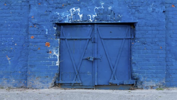 Old blue door closed in a wall