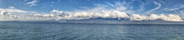 Garda Lake coast on a sunny day with beautiful clouds