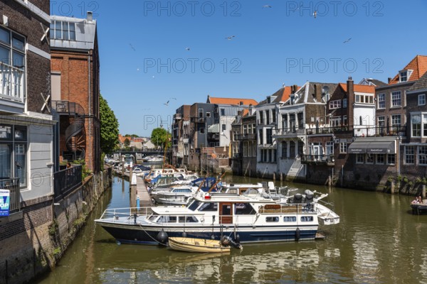 Dordrecht, Netherlands, May 8, 2022: Scenic view of the old town of Dordrecht in Western Netherlands. Canal with vessels