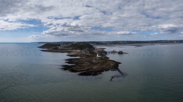 Aerial view of the Mumbles headland with the historic lighthouse and piers in Swansea Bay