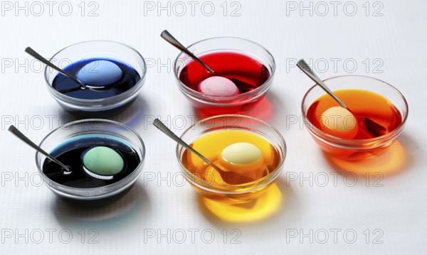 Five bowls with eggs in different coloured dye