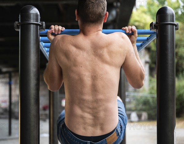 43 year old white sporty man pulling up outdoors, Brussels, Belgium, Europe