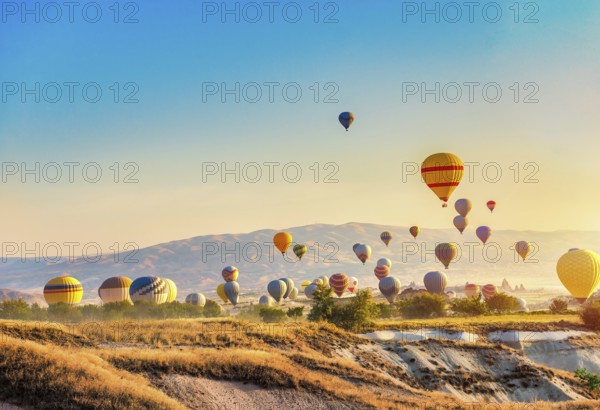 Morning sun and hot air balloons in Cappadocia