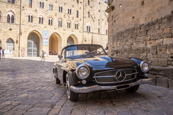 VOLTERRA, ITALY, OCTOBER 15, 2023, A Mercedes Benz 190SL vintage car in the town center of Volterra in the Tuscany