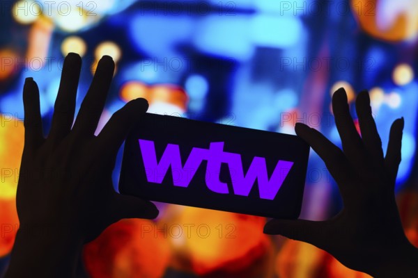 In this photo illustration, the Willis Towers Watson (WTW) logo is displayed on a smartphone mobile screen