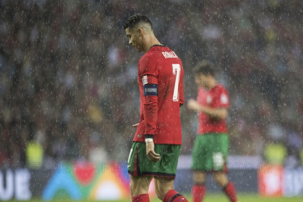Football match, Cristiano RONALDO CR7 Portugal in the pouring rain, walking to the left and with his head slightly down, captain's armband on his left arm, Estadio do Dragao, Porto, Portugal, Europe