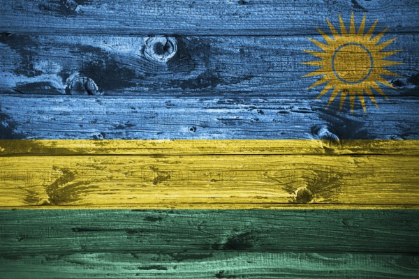 Rwanda flag on wooden planks background wood flag
