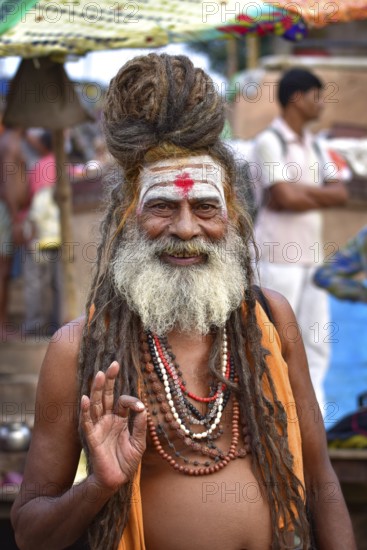 Portrait of a sadhu on ghat by Ganges river, Varanasi, India, Asia