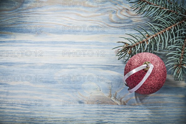 Fir branch red Christmas ball on wooden board celebrations concept
